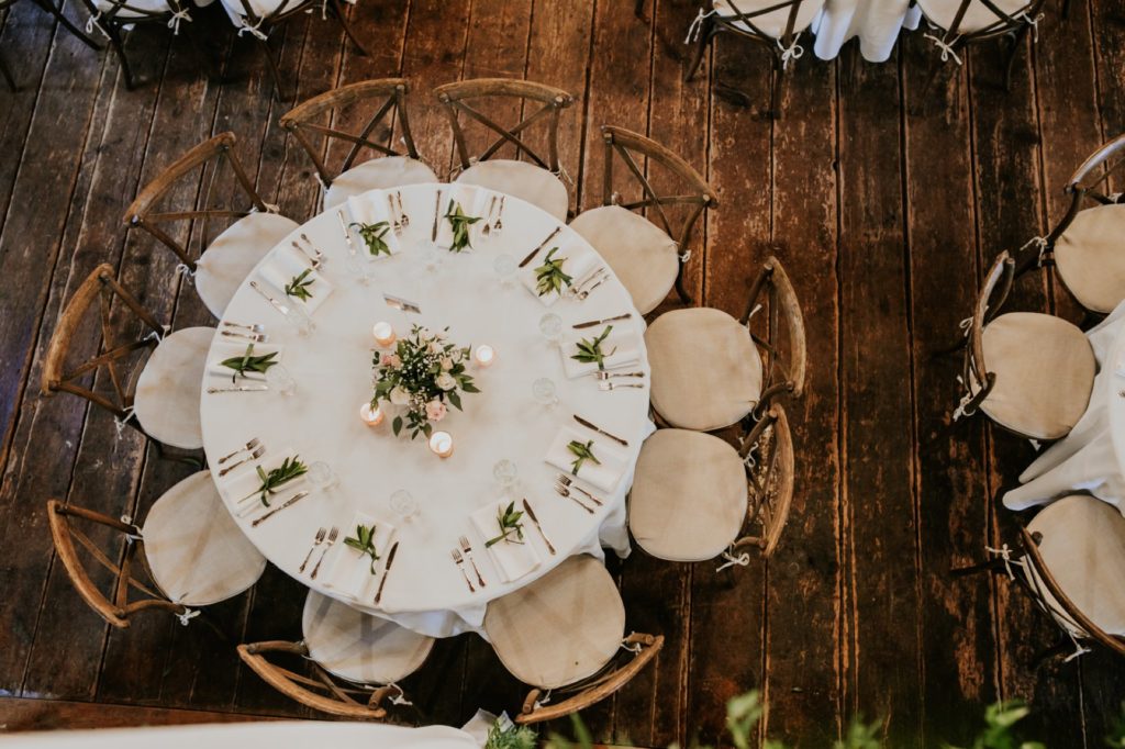 overhead shot of tables set up in barn at mustard seed gardens
