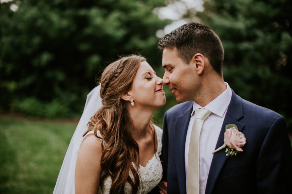 bride and groom rub noses together and smile during their Noblesville Wedding Photography