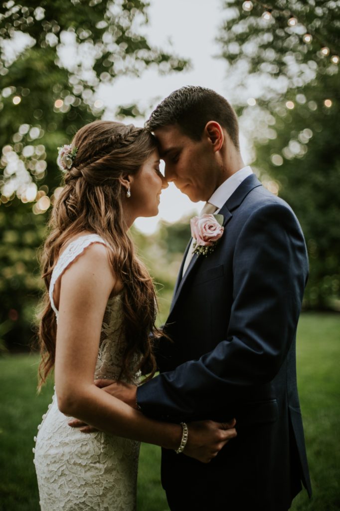 bride and groom touch foreheads at sunset at mustard seed gardens for Noblesville Wedding Photography