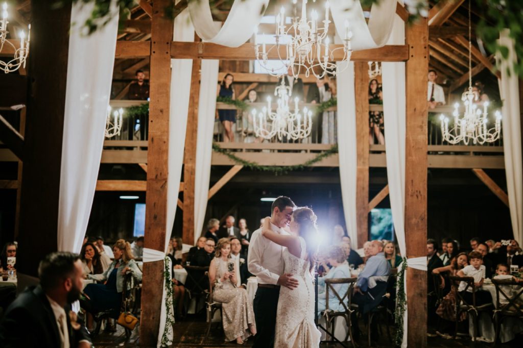 bride and groom dance in wide shot under chandelier at mustard seed gardens for Noblesville Wedding Photography
