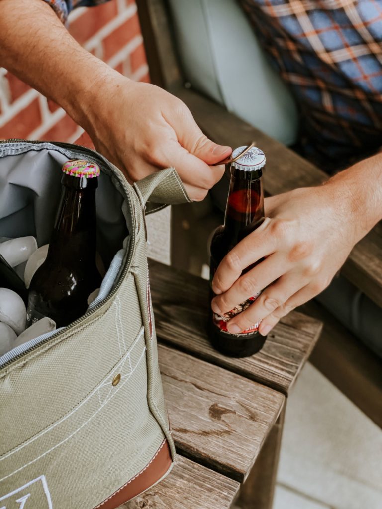 man in flannel opens beer with bottle opener from groovy guy gifts