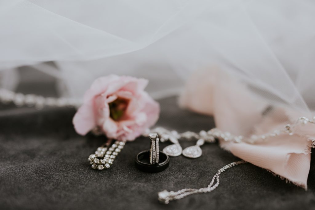 rings, flowers, and jewelry on suede for a Regions Tower wedding
