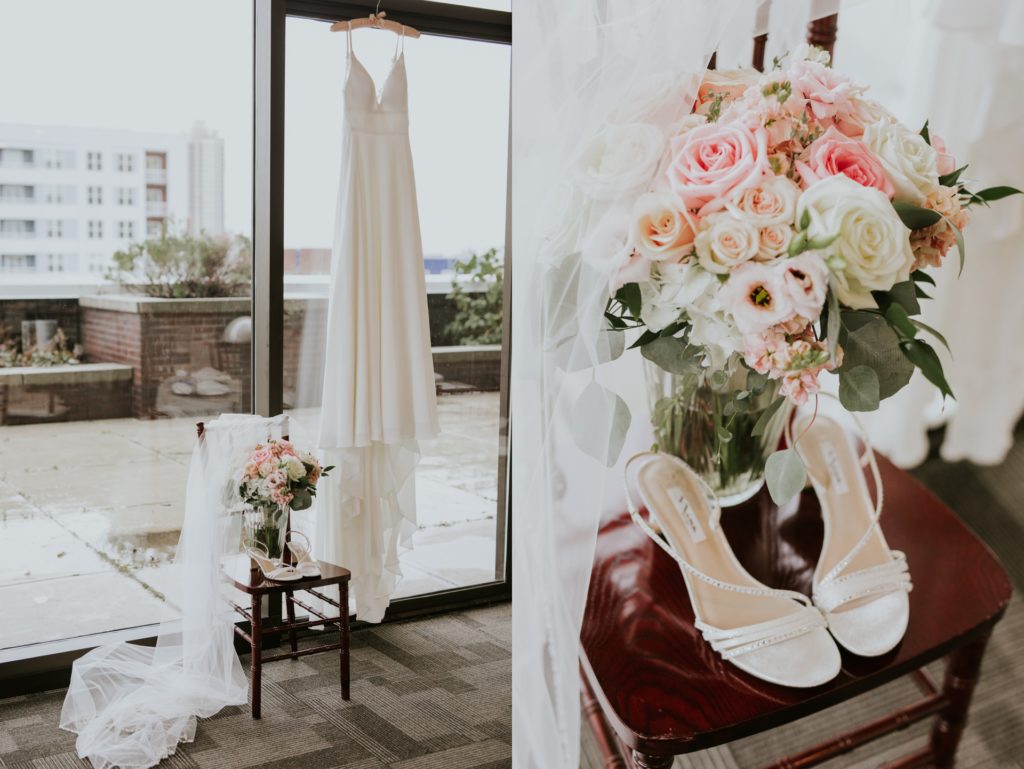 wedding dress hanging in window and wedding shoes and flowers in window at a Regions Tower wedding