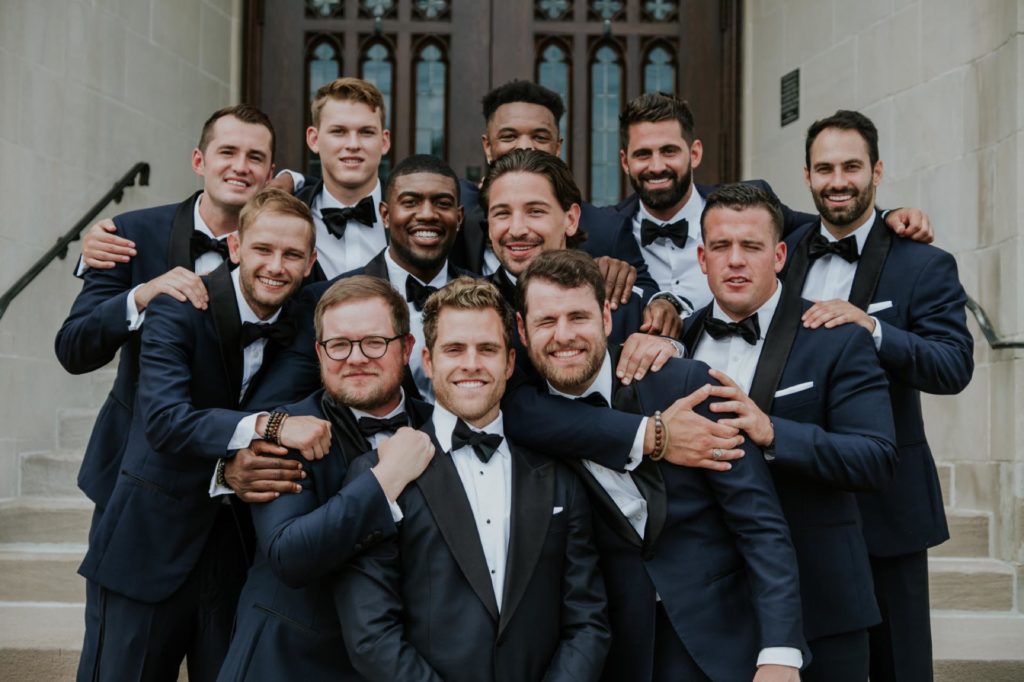 groom and groomsmen smiling and laughing at tabernacle presbyterian wedding photography