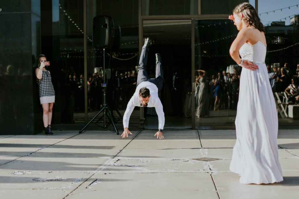 groomsman does the worm for regions tower wedding photographer