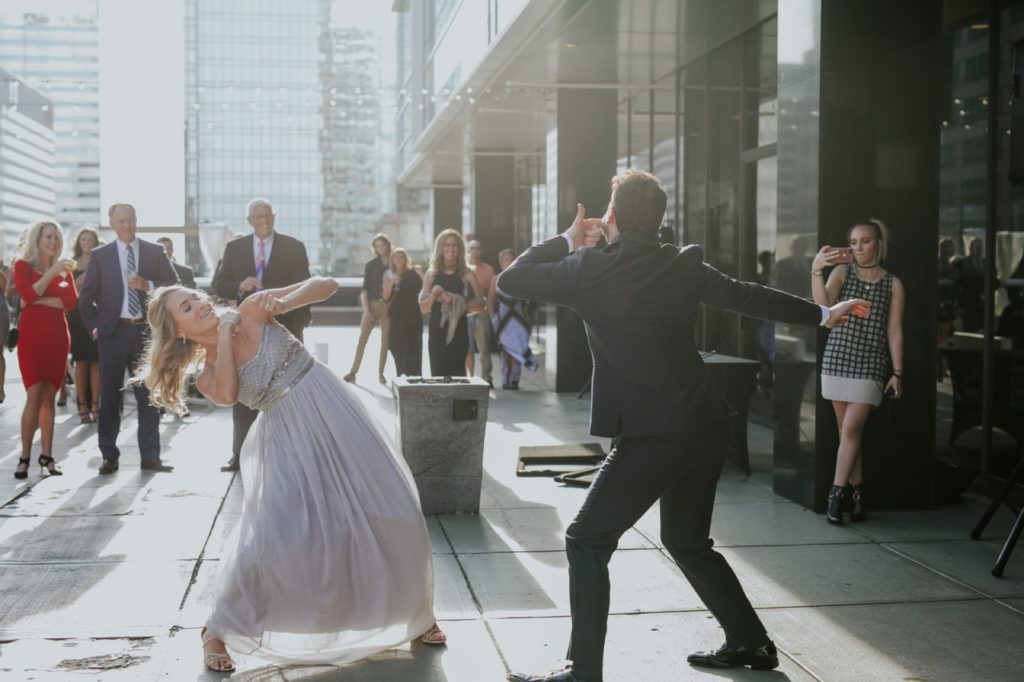 bridesmaid and groomsman dance during grand entrance for regions tower wedding