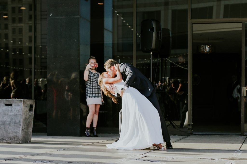 bride and groom kiss during grand entrance for Indy wedding photographer