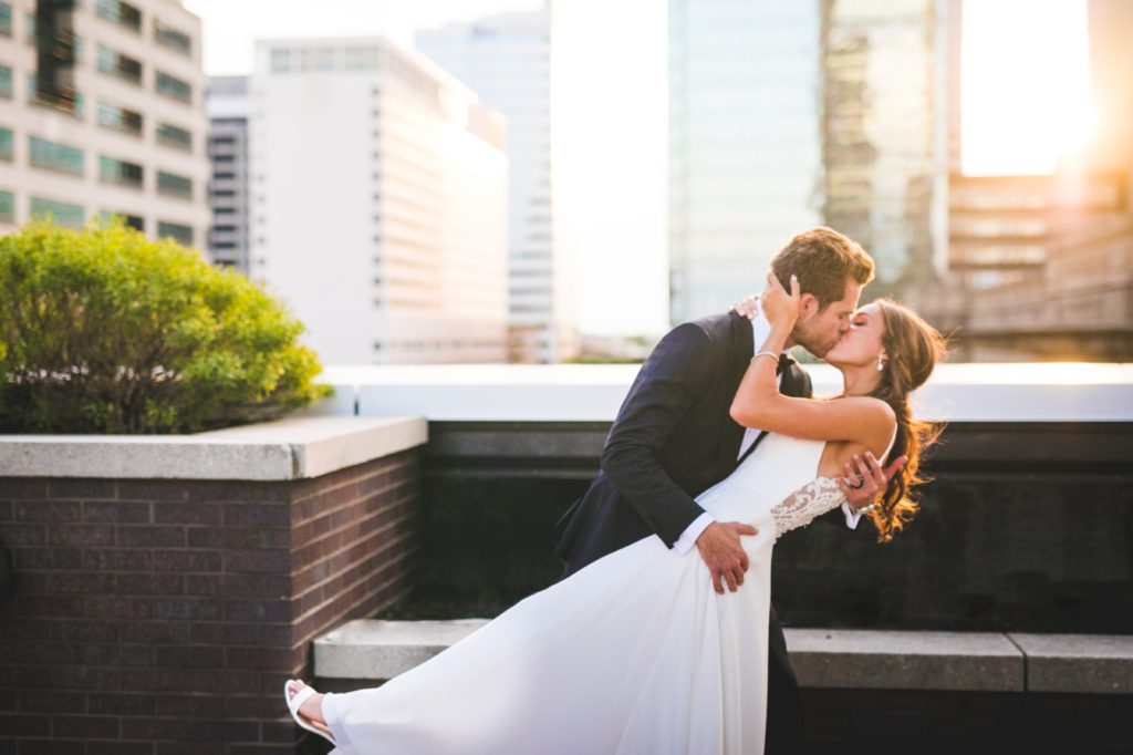 bride and groom dip and kiss for Regions Tower wedding Indy photographer