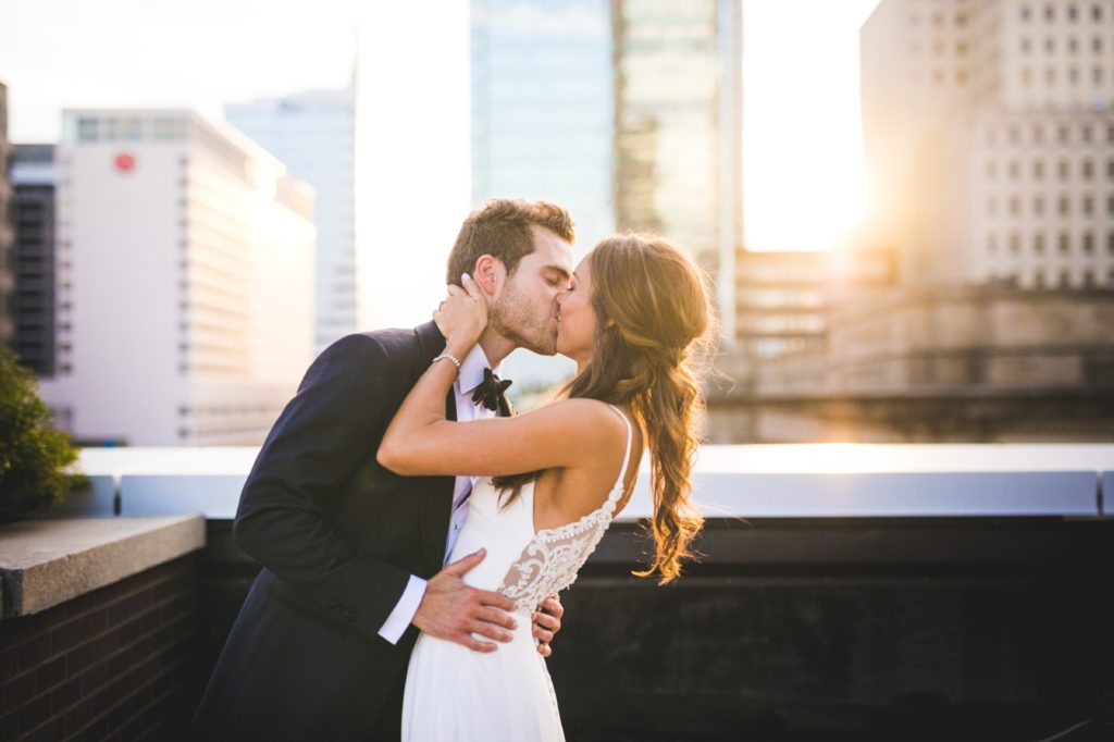 bride and groom kiss at sunset during Regions Tower wedding Indianapolis Wedding Photographer