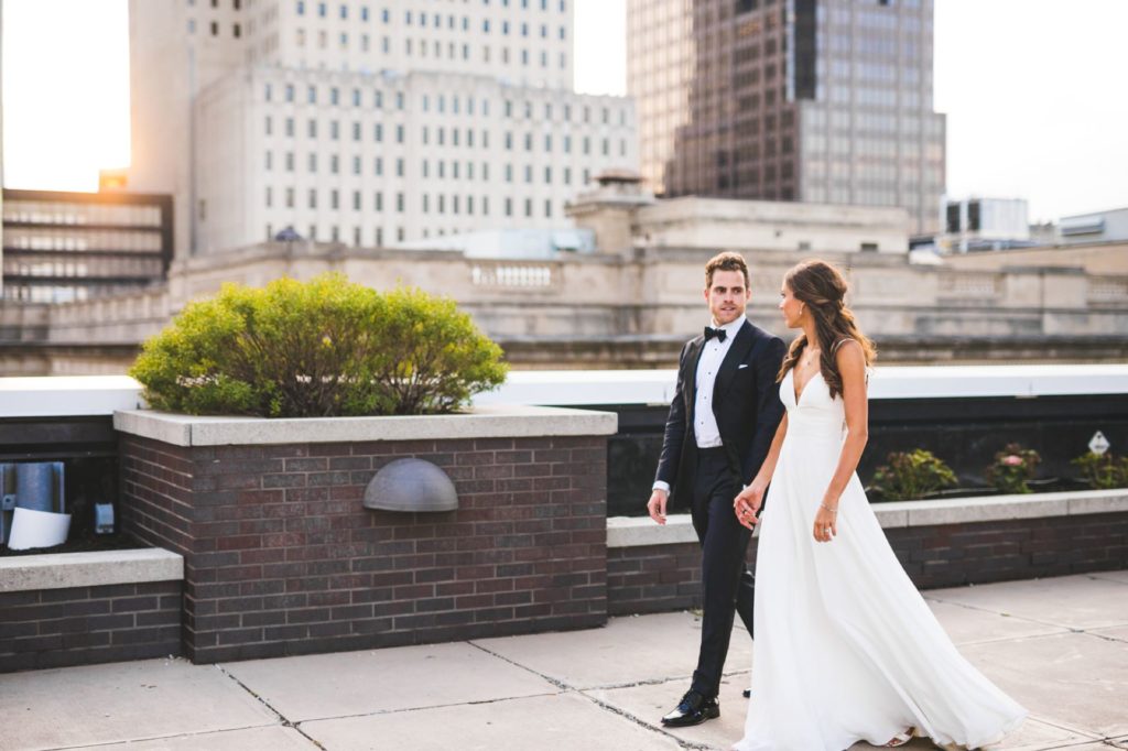 bride and groom walk on regions tower rooftop for indianapolis photographer