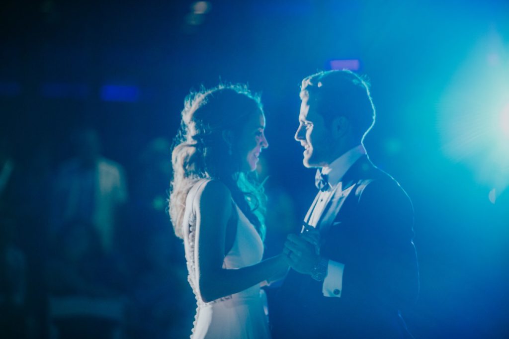 bride and groom dance in blue light at night for their Indy Wedding Photography at Regions Tower