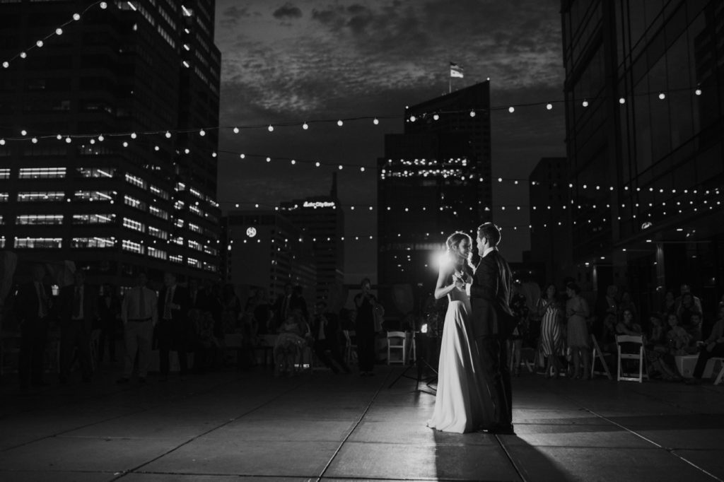 black and white photo of bride and groom dancing on rooftop at Regions Tower wedding in indianapolis photography