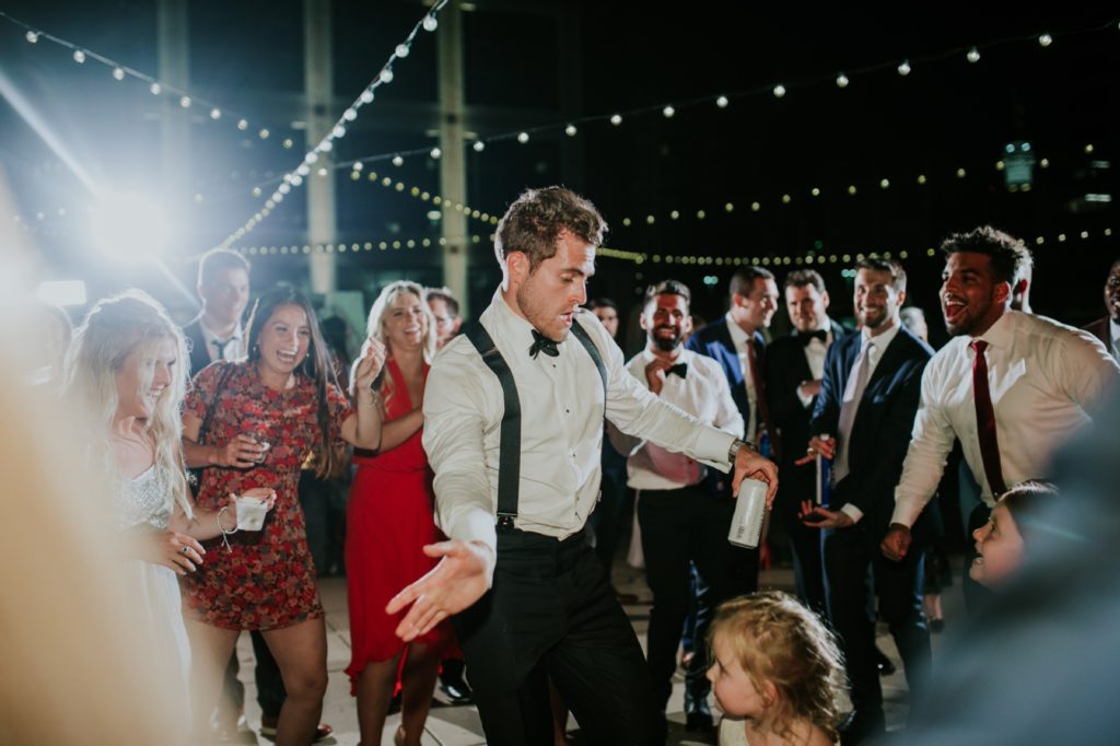 groom dances during Regions Tower wedding for indy photographer