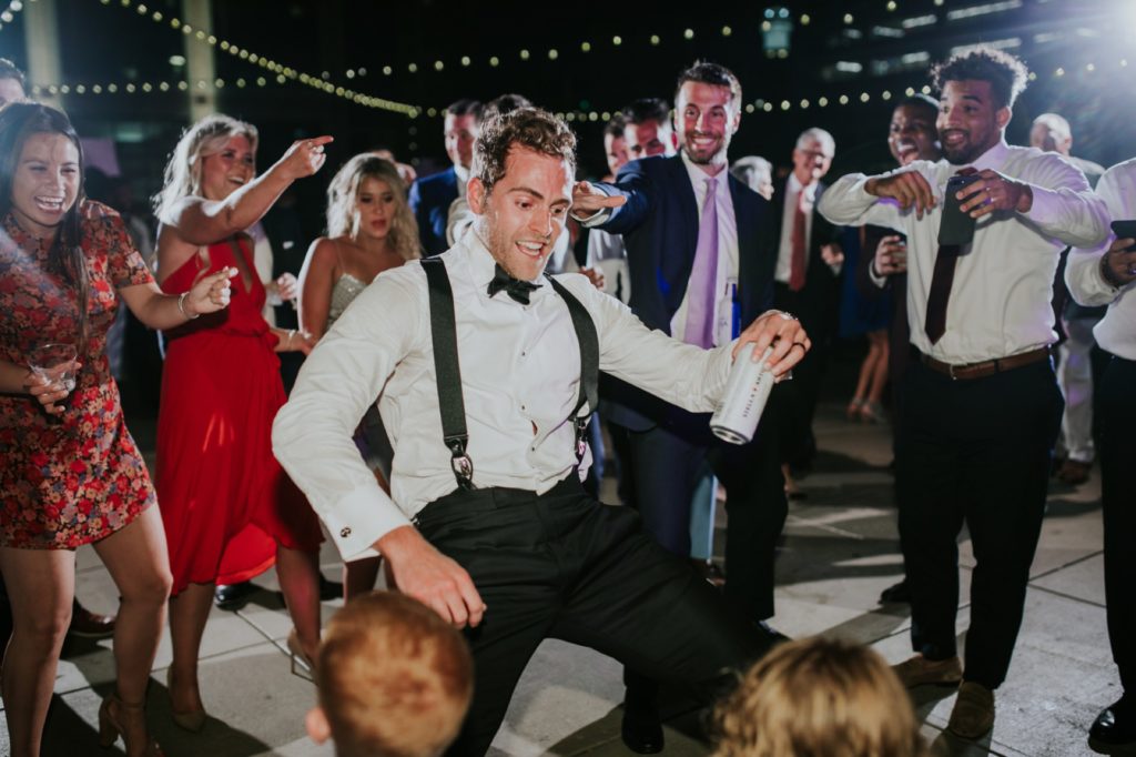 groom dancing in a circle for indianapolis wedding photographer