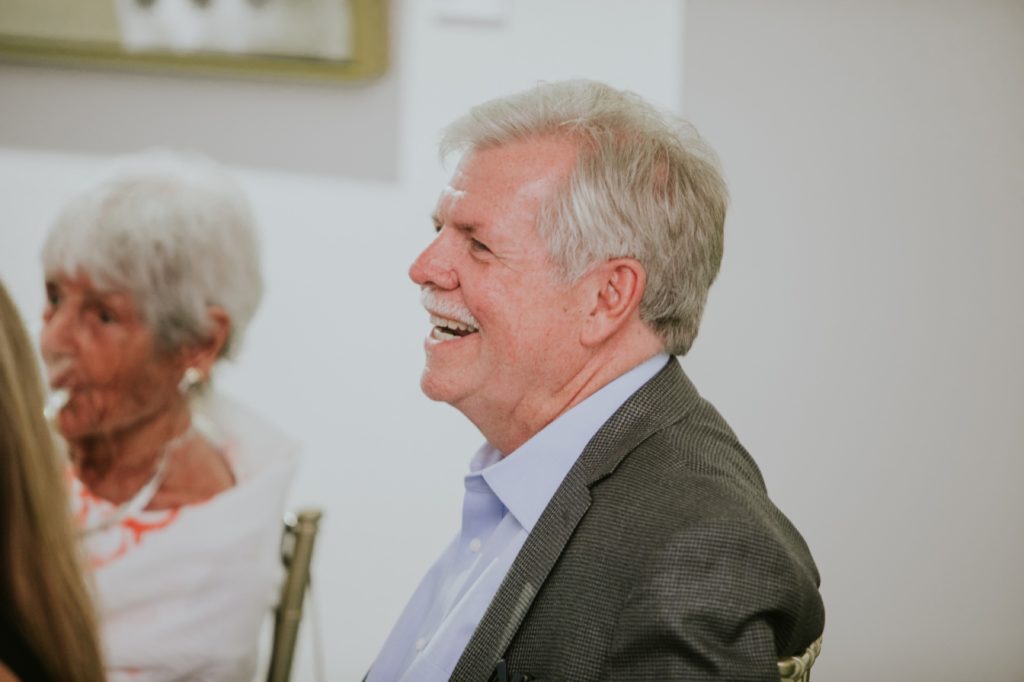 a man with white hair and a white mustache laughs at Conrad Indianapolis Event Photography