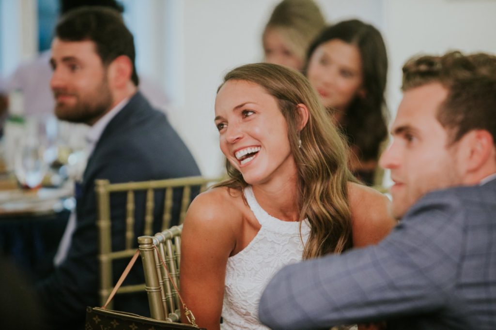 the bride laughs during the speeches at the rehearsal dinner at Conrad Indianapolis Event Photography