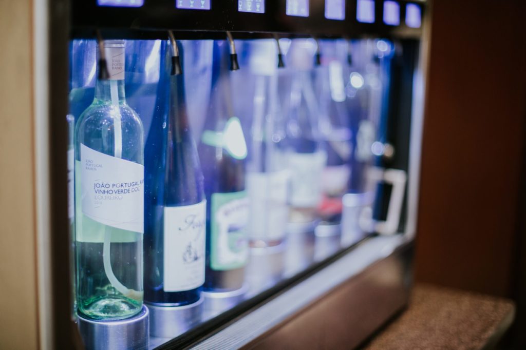 bottles of wine lined up in a case in Tastings event photography in Indy