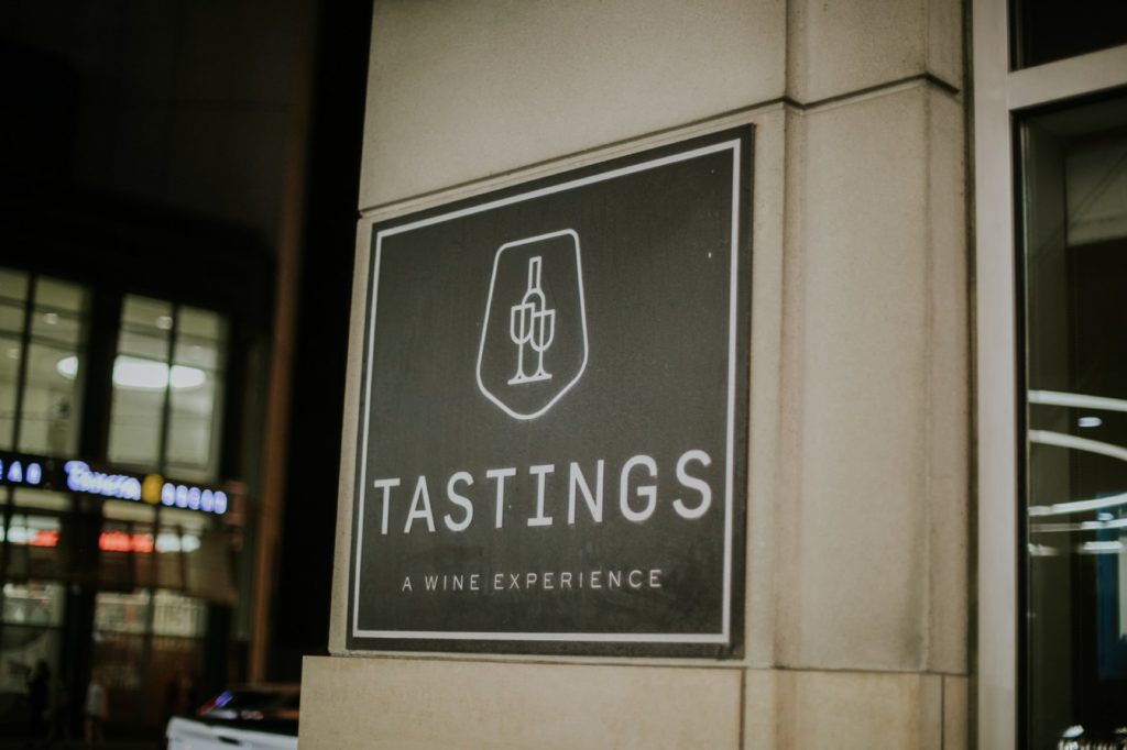 Tastings sign on front entryway of the building