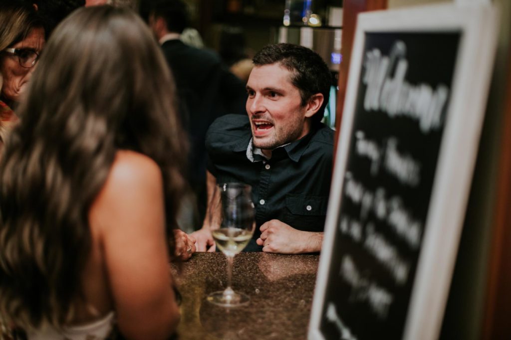 man slumped on counter talking to woman at Tastings Bar and Bistro indy event photographer