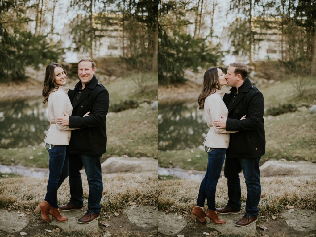 man and woman hug and kiss during their holcomb gardens winter engagement shoot