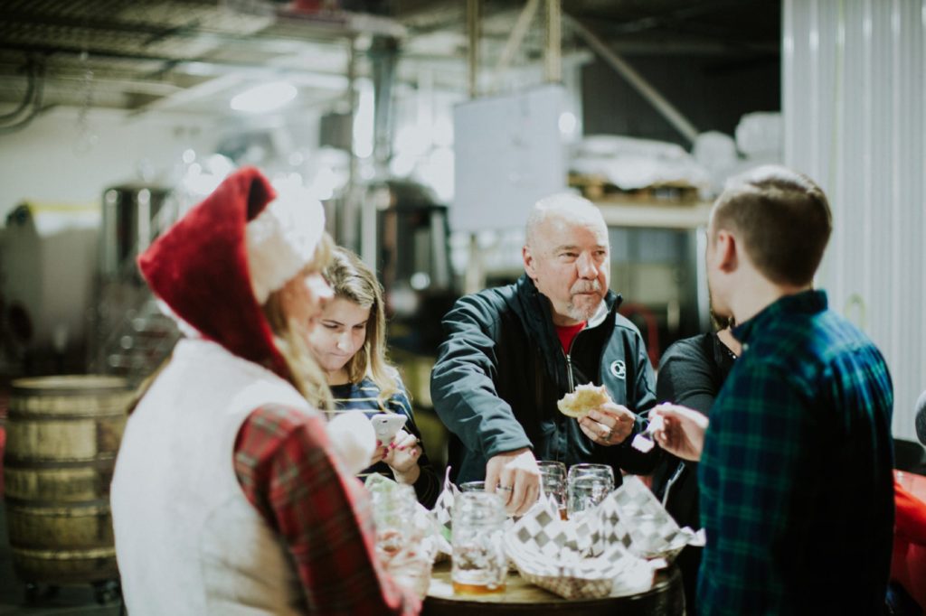 people drinking at a table in scarlet lane brewery