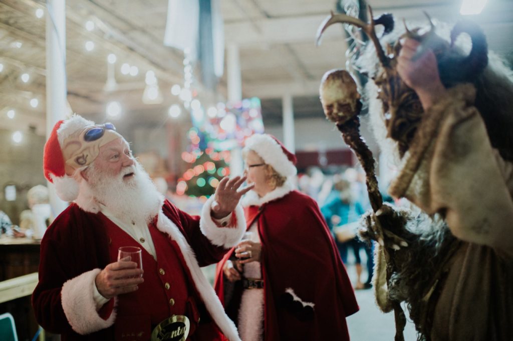 santa with alien mask is spooked by krampus at this herst with scarlet lane brewing company logo on back at this Indianapolis Brewery Event Photography