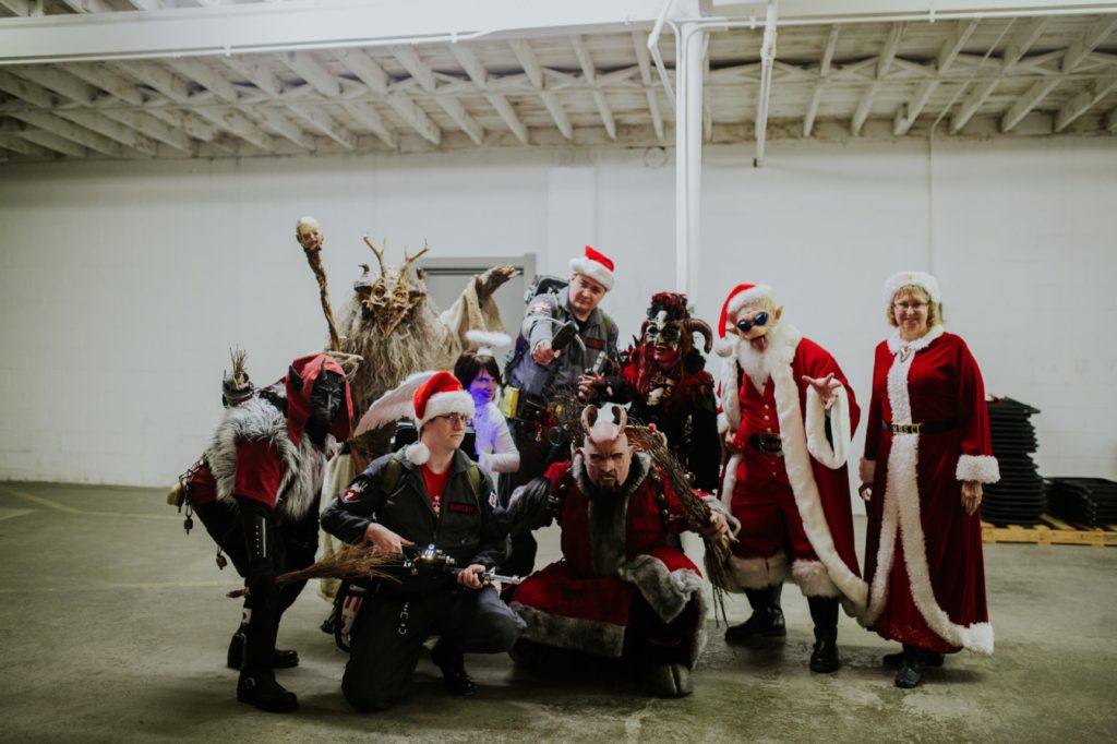 alien santa, krampus, and ghostbusters pose for photos together at this herst with scarlet lane brewing company logo on back at this Indianapolis Brewery Event Photography