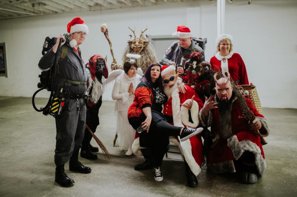 scarlet lane founder takes photo with ghostbusters, krampus, and alien santa and angel at this herst with scarlet lane brewing company logo on back at this Indianapolis Brewery Event Photography