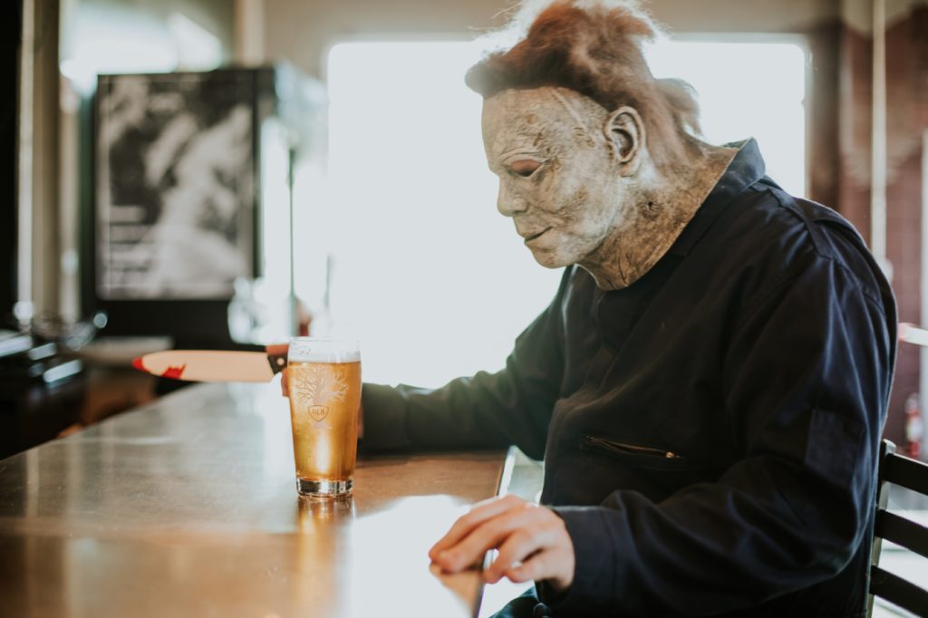 man with leathery face drinks beer at scarlet lane brewery in this Indianapolis brewery photography