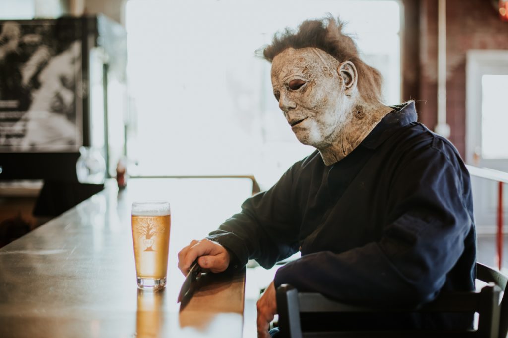leather faced man questions the meaning of life while having a beer at the bar