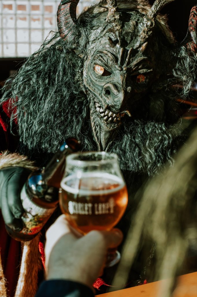 krampus knocks back a beer at scarlet lane for this Indianapolis brewery photography