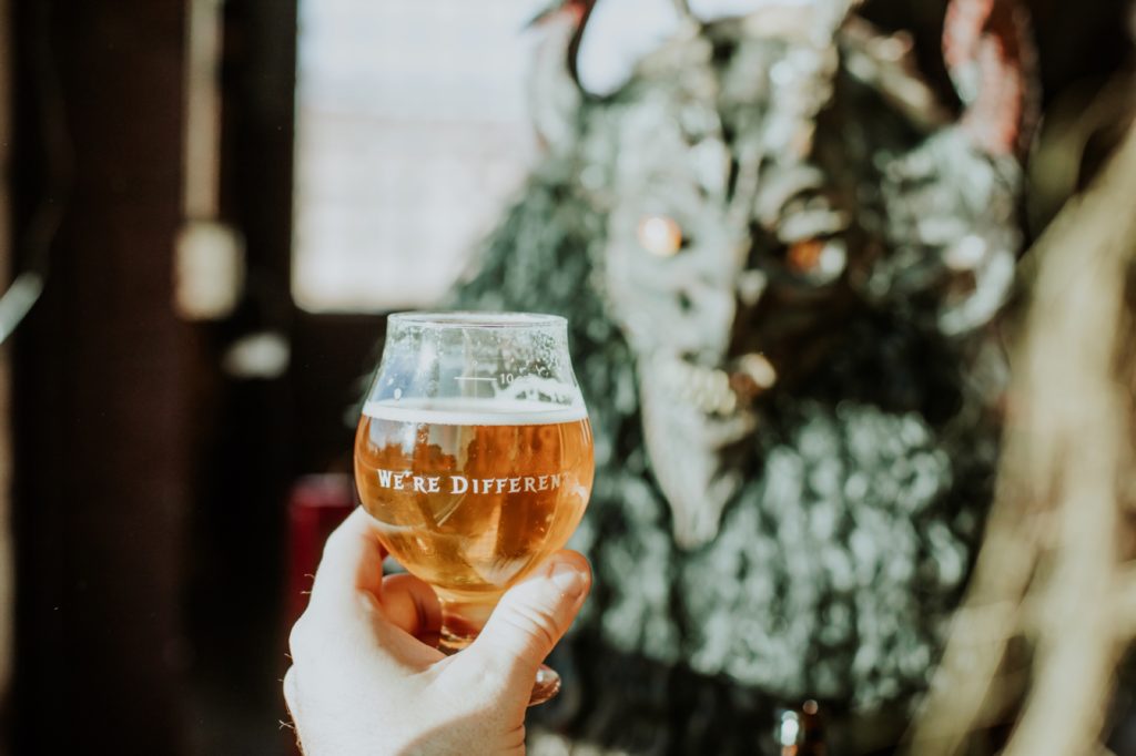 scarlet lane beer in focus in front of krampus for this Indianapolis brewery photography