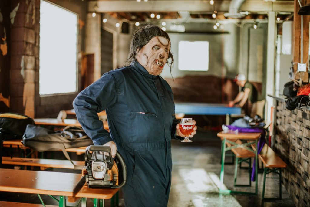 man with chainsaw drinks beer for this Indianapolis brewery photography