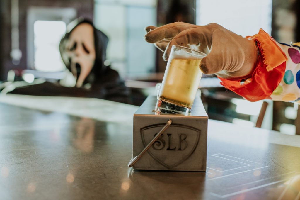 a ghost watches a man drink a flight of beer in this Indianapolis brewery photography