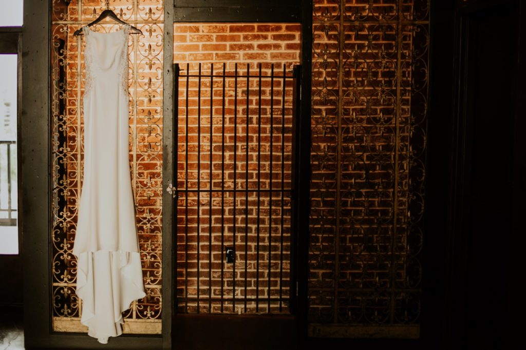 wedding dress hanging from metal gate at an industrial wedding in indianapolis