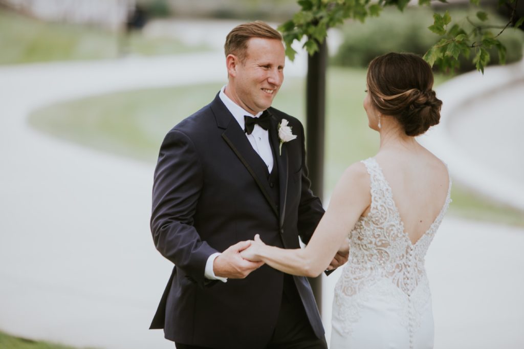 groom smiles wide when he sees his bride for the first time at the indianapolis canal