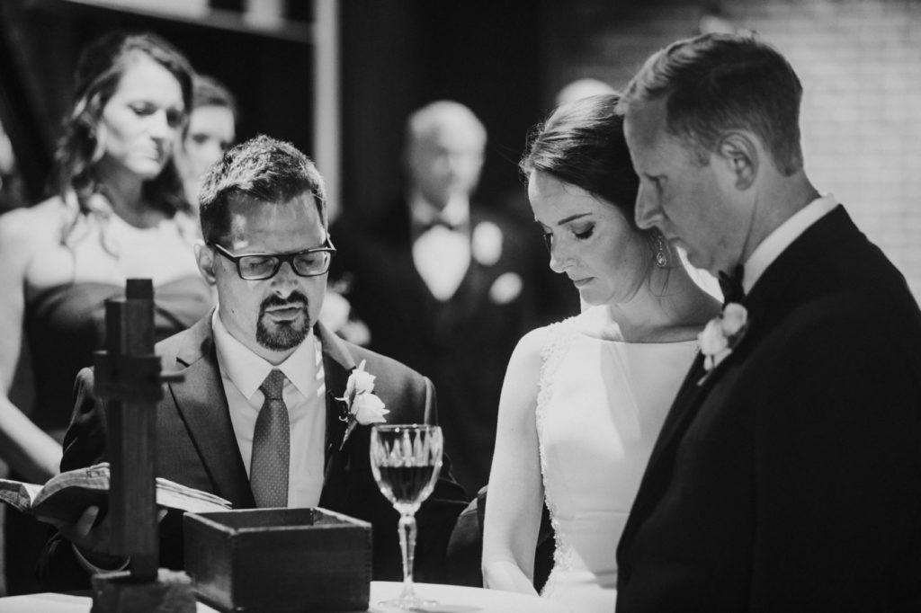 black and white photo of bride and groom taking communion during canal 337 wedding