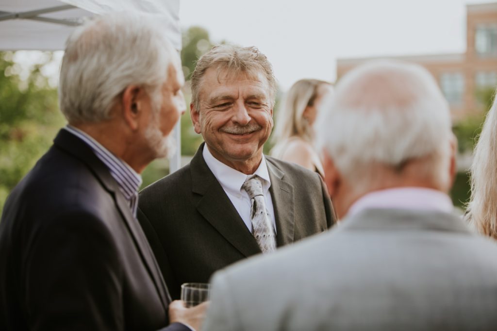 older men smile at a canal 337 wedding