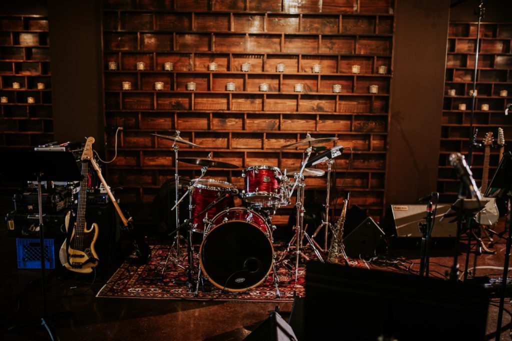 drum kit in front of candles at a canal 337 wedding