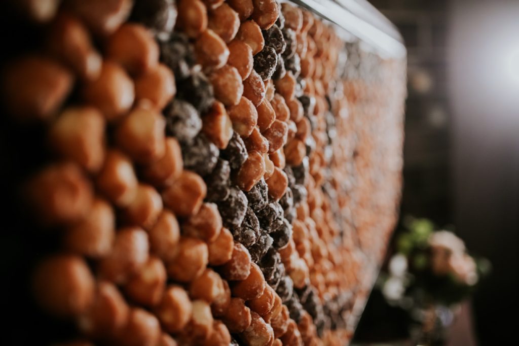 close up shot of donut holes on donut wall at a canal 337 wedding