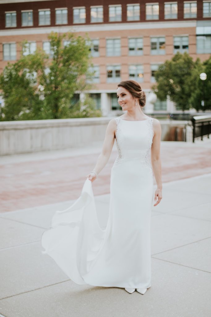 bride playing with dress in front of the indianapolis canal at a canal 337 wedding