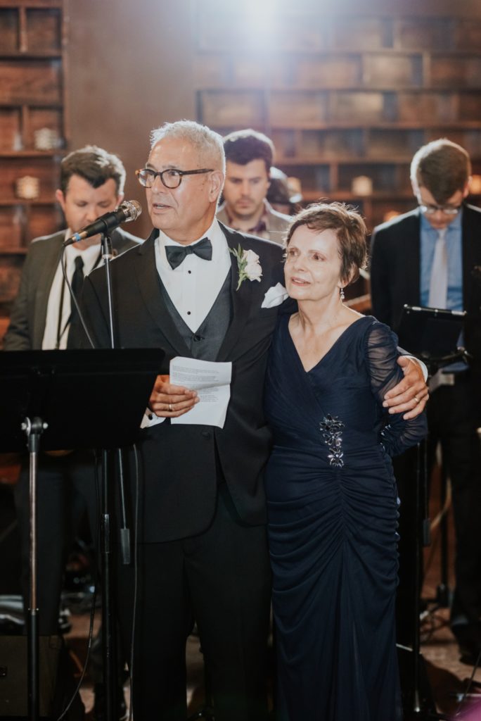 parents of bride deliver a speech to guests at a canal 337 wedding reception