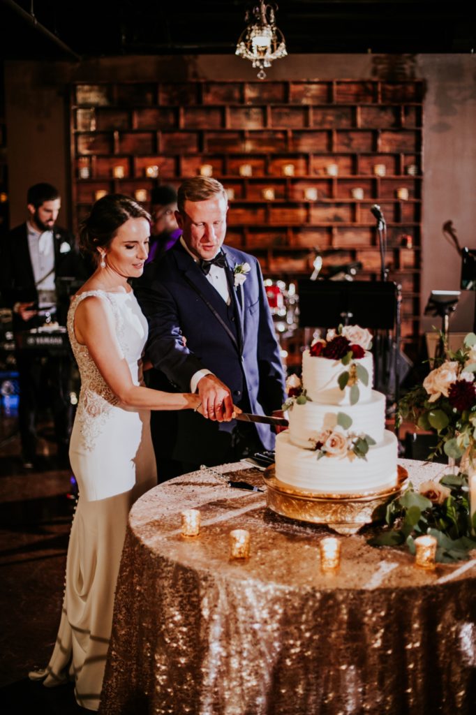 bride and groom cut cake at a canal 337 wedding
