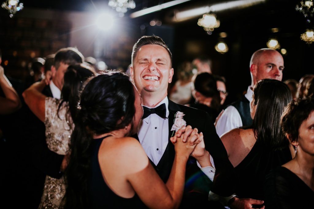 brother of bride laughs and dances with wife at a canal 337 wedding