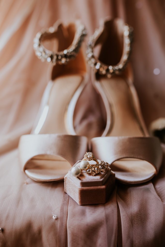 high heels badgley mischka shoes on bridesmaid dress with rings in front of them on ring box for Bel Air Kokomo Wedding