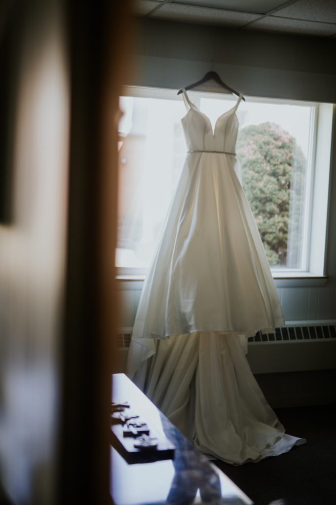Wedding dress hanging in window before Bel Air Kokomo Wedding