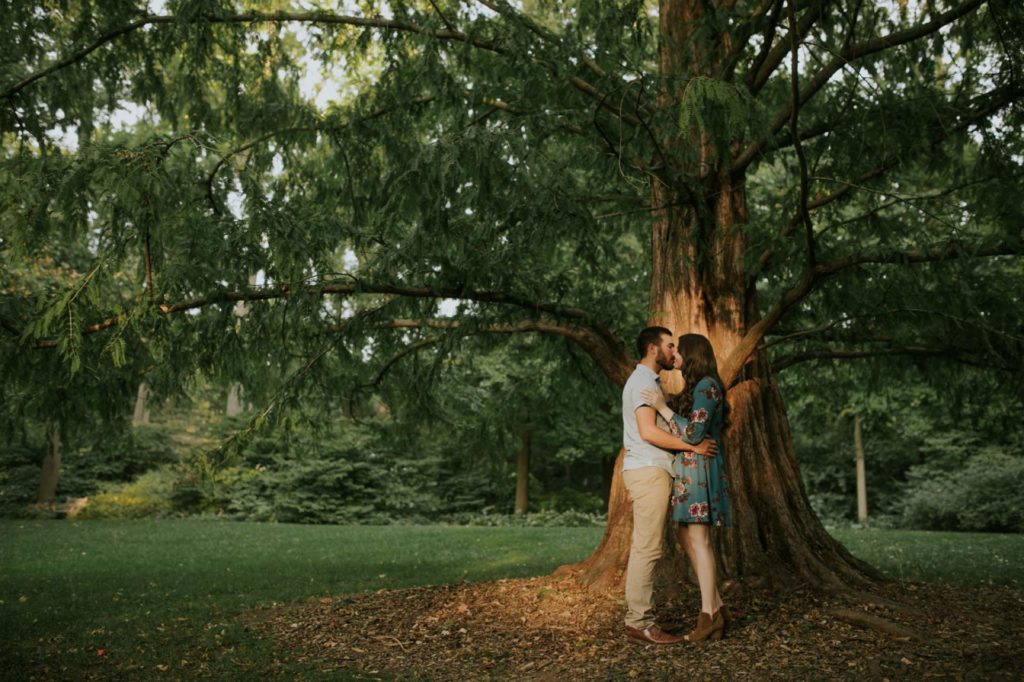 man and woman stand in one patch of sunlight during their IMA engagement session