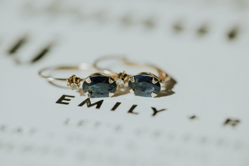 ear rings rest on an invitation over the word Emily at the blumlux building in indy
