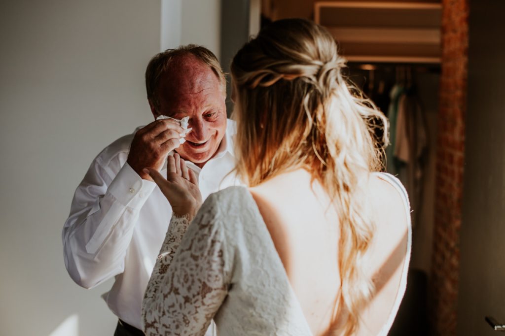 father of the bride cries during first look with bride at blumlux building in indianapolis