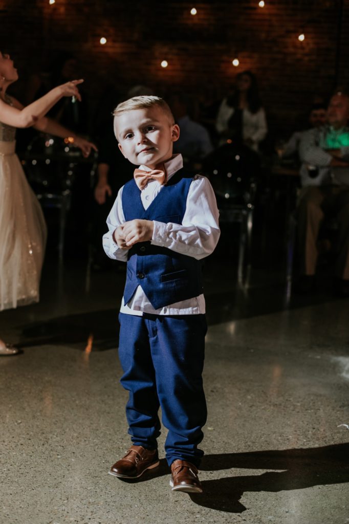 young boy in suit on dance floor at a VisionLoft Wedding